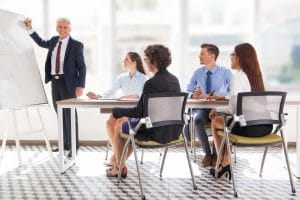 Smiling senior businessman conducting presentation